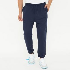 Spodnie sportowe unisex F BALLON niebieskie. Niebieskie spodnie dresowe LEGEA, bez wzorów, z gumy, na fitness i siłownię. W wyprzedaży za 92.00 zł.