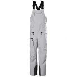 Kombinezon narciarski damski z szelkami Helly Hansen Powderqueen 2.0. Szare kombinezony Helly Hansen, na zimę, bez wzorów, sportowe, bez kołnierzyka, bez ramiączek. Za 1,179.55 zł.