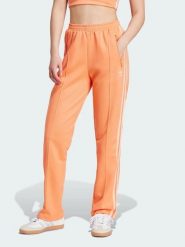 Adidas Spodnie dresowe w kolorze pomarańczowym rozmiar: XS. Pomarańczowe spodnie dresowe adidas, bez wzorów, z dresówki. Za 123.25 zł.