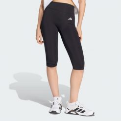 Legginsy Optime Essentials Capri. Czarne legginsy adidas, bez wzorów, z elastanu, eleganckie. Za 199.00 zł.