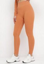 Pomarańczowe Legginsy z Elastycznej Prążkowanej Dzianiny Ichorsa. Brązowe legginsy Born2be, bez wzorów, z dzianiny. Za 59.99 zł.