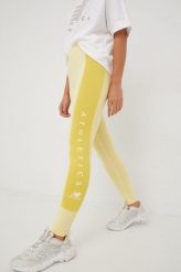 New Balance legginsy treningowe NB Athletics damskie kolor żółty wzorzyste. Żółte legginsy New Balance, bez wzorów, z bawełny. W wyprzedaży za 149.99 zł.
