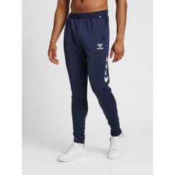 Spodnie joggingowe Hummel hmlCORE. Niebieskie spodnie dresowe Hummel, bez wzorów, z dresówki. Za 170.30 zł.