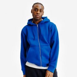 Bluza na suwak unisex Elementals. Niebieskie bluzy Decathlon, uniwersalny, bez wzorów, z bawełny, bez ramiączek, z kapturem. Za 199.99 zł.