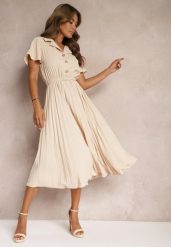 Beżowa Plisowana Rozkloszowana Sukienka z Paskiem Guzikami i Gumką w Talii Nelaika. Brązowe sukienki Renee, na co dzień, l, bez wzorów, eleganckie, bez kołnierzyka, bez ramiączek, midi, kopertowe. W wyprzedaży za 97.99 zł.