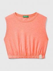 Benetton Top w kolorze jasnoróżowym rozmiar: 140. Pomarańczowe topy Benetton, bez wzorów, z bawełny, bez kołnierzyka, bez ramiączek. Za 26.44 zł.
