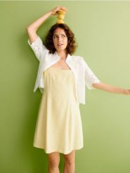 Ażurowa koszula - złamana biel. Koszule Reserved, l, w ażurowe wzory, z bawełny, bez kołnierzyka, bez ramiączek. W wyprzedaży za 79.99 zł.