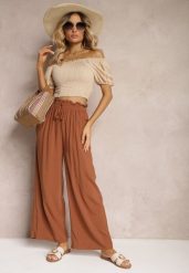 Brązowe Spodnie z Bawełny High Waist z Szerokimi Nogawkami i Gumką w Pasie Clisea. Brązowe jeansy Renee, na lato, l, bez wzorów, z bawełny, z podwyższonym stanem. W wyprzedaży za 31.99 zł.