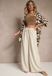Beżowe Spodnie z Bawełną o Szerokim Kroju High Waist z Wiązaniem Noleldi. Brązowe jeansy Renee, bez wzorów, z bawełny, eleganckie, z podwyższonym stanem. W wyprzedaży za 20.99 zł.