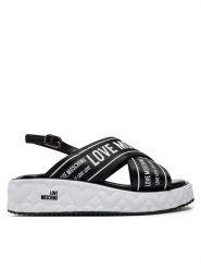 LOVE MOSCHINO Sandały JA16315I0IIX300A Czarny. Czarne sandały Love Moschino, bez wzorów, ze skóry, bez obcasa, na płaskiej podeszwie, bez zapięcia. Za 1,259.00 zł.