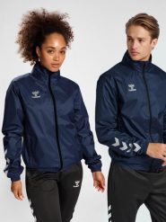 Kurtka ortalionowa piłkarska dla dorosłych Hummel Core XK Spray Jacket. Niebieskie kurtki Hummel, m, bez wzorów, z materiału, klasyczne, z kapturem. Za 181.20 zł.