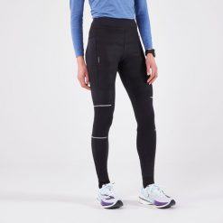 Legginsy do biegania damskie Kiprun Warm Rain ocieplane. Czarne legginsy KIPRUN, bez wzorów, z elastanu, sportowe. Za 189.99 zł.