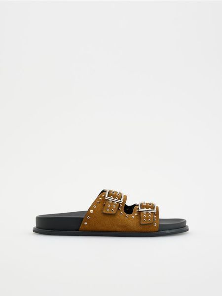 Zamszowe klapki z okuciami - brązowy. Brązowe klapki Reserved, bez wzorów, z zamszu, bez obcasa, bez zapięcia. W wyprzedaży za 49.99 zł.