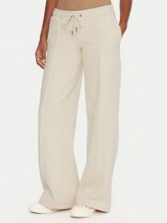 Guess Jeans Spodnie dresowe W5BB04 KC811 Beżowy Wide Leg. Brązowe spodnie dresowe Guess Jeans, z aplikacjami, z bawełny. Za 349.99 zł.