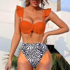 Strój kąpielowy z wysokim stanem modelujący brzuch plażowy Lidwina. Stroje jednoczęściowe Intica, bez wzorów, z materiału, klasyczne. Za 129.00 zł.