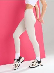 Sportowe legginsy z wycięciem V w talii Gym Hard - kremowy. Białe legginsy Sinsay, l, bez wzorów. Za 39.99 zł.