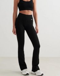 Damskie legginsy bezszwowe, prążkowane, wysoki stan, dzwony, długie, czarne. Czarne legginsy AIM'N, bez wzorów, z elastanu, długie. Za 301.00 zł.