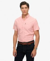 Superdry Koszula Oxford krótki rękaw Rose Pink Chambray z bawełny organicznej. Czerwone koszule Superdry, l, bez wzorów, z bawełny, klasyczne, bez kołnierzyka, bez ramiączek. Za 336.50 zł.