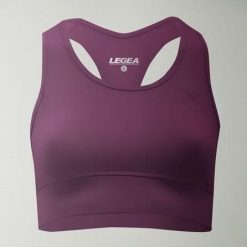 Crop top sportowy treningowy FEBE. Fioletowe biustonosze sportowe LEGEA, bez wzorów, z materiału, na fitness i siłownię. W wyprzedaży za 84.50 zł.