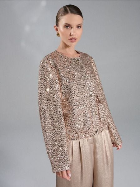 Żakiet z połyskującymi cekinami - złoty. Żółte marynarki i żakiety Sinsay, l, bez wzorów, bez ramiączek. Za 69.99 zł.