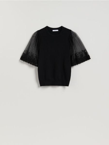 Bluzka z ozdobnymi rękawami - czarny. Czarne bluzki Reserved, l, bez wzorów, z dzianiny, bez kołnierzyka, bez ramiączek. Za 99.99 zł.