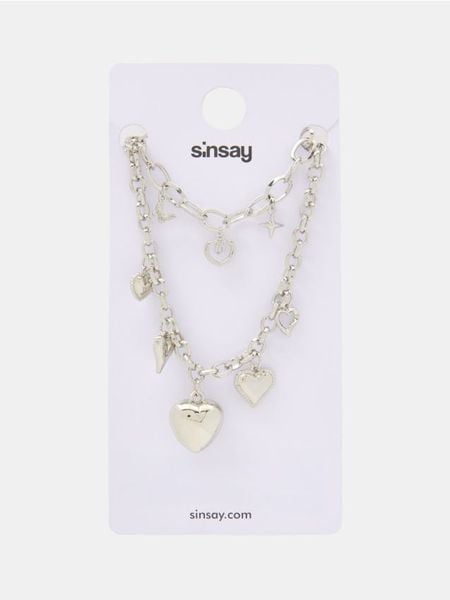 Zestaw biżuterii: naszyjnik i bransoletka - srebrny. Szare naszyjniki Sinsay, srebrne. Za 19.99 zł.