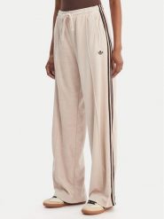 Adidas Spodnie dresowe Terry Towel Firebird KQ6661 Beżowy Loose Fit. Brązowe spodnie sportowe adidas, bez wzorów, z bawełny. Za 349.99 zł.