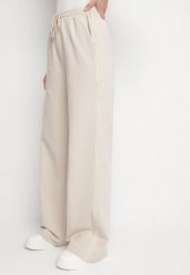 Beżowe Bawełniane Spodnie Dresowe o Szerokim Kroju z Lampasami Alarita. Brązowe jeansy Born2be, l, bez wzorów, z bawełny, eleganckie, z podwyższonym stanem. Za 149.99 zł.