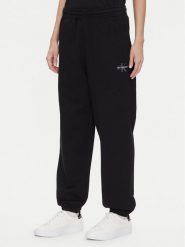 Calvin Klein Jeans Spodnie dresowe Monologo LV047B235G Czarny Regular Fit. Czarne spodnie dresowe Calvin Klein Jeans, bez wzorów, z bawełny. Za 389.99 zł.