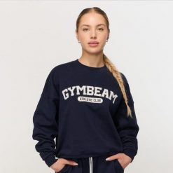 Bluza damska fitness bez kaptura niebieska Varsity. Niebieskie bluzy GYMBEAM, l, bez wzorów, z bawełny, klasyczne, bez ramiączek, bez kaptura. Za 139.90 zł.