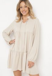 Beżowa Rozkloszowana Sukienka z Falbanką Uxaria. Brązowe sukienki Born2be, uniwersalny, z aplikacjami, eleganckie, bez kołnierzyka, bez ramiączek, mini, rozkloszowane. W wyprzedaży za 93.49 zł.