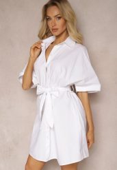 Biała Koszulowa Sukienka Bawełniana z Wiązanym Paskiem Neliva. Białe sukienki Renee, xl, bez wzorów, z bawełny, eleganckie, bez kołnierzyka, bez ramiączek, mini, koszulowe. W wyprzedaży za 55.99 zł.