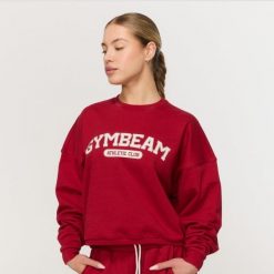 Bluza damska fitness bez kaptura czerwona Varsity. Czerwone bluzy GYMBEAM, xs, bez wzorów, z bawełny, klasyczne, bez ramiączek, bez kaptura. Za 139.90 zł.