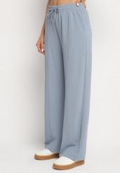 Niebieskie Szerokie Spodnie z Wysokim Stanem i Wiązaniem Deannie. Niebieskie jeansy Born2be, bez wzorów, z gumy, eleganckie, z podwyższonym stanem. W wyprzedaży za 50.99 zł.