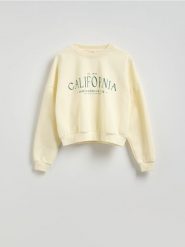 Bluza oversize z nadrukiem - kremowy. Białe bluzy Reserved, l, bez wzorów, z bawełny, bez ramiączek, bez kaptura. W wyprzedaży za 49.99 zł.