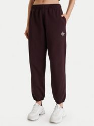 Calvin Klein Jeans Spodnie dresowe Monologo LV047B235G Brązowy Regular Fit. Brązowe spodnie dresowe Calvin Klein Jeans, bez wzorów, z bawełny. Za 309.99 zł.