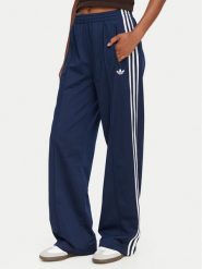 Adidas Spodnie dresowe Firebird KV5403 Niebieski Loose Fit. Niebieskie spodnie dresowe adidas, bez wzorów, z dresówki. Za 299.99 zł.