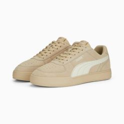 Buty sportowe unisex Puma CAVEN beżowe 39193902 r 46. Brązowe buty treningowe Puma, bez wzorów, ze skóry, bez zapięcia, do koszykówki. Za 184.03 zł.