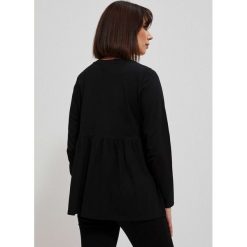Bawełniana bluzka z falbaną. Bluzki MOODO, l, bez wzorów, z bawełny, bez kołnierzyka, bez ramiączek. Za 69.99 zł.
