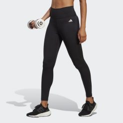Legginsy treningowe z wysoką talią damskie 7/8 adidas Essentials. Czarne legginsy adidas, bez wzorów, z materiału, sportowe. W wyprzedaży za 181.75 zł.