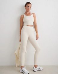Damskie legginsy, wysoki stan, squat proof, modelujące Sculpting Fit beżowe. Brązowe legginsy AIM'N, bez wzorów, z materiału, długie. Za 391.00 zł.