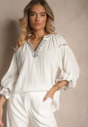 Biała Bluzka z Bawełny Ozdobiona Haftem Isdexira. Białe bluzki Renee, l, bez wzorów, z bawełny, eleganckie, bez kołnierzyka, bez ramiączek. W wyprzedaży za 59.99 zł.