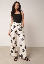Czarno-Kremowe Spodnie o Szerokim Kroju z Wysokim Stanem w Kwiaty Ozdobione Wiązaniem Neatea. Brązowe spodnie materiałowe Born2be, bez wzorów, z jeansu, biznesowe, z podwyższonym stanem. Za 49.99 zł.