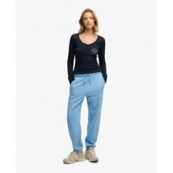 Kobieta z długim rękawem T-shirt z guzikami Superdry Athletic. Niebieskie t-shirty sportowe Superdry, s, bez wzorów, z dresówki, bez ramiączek. Za 193.00 zł.