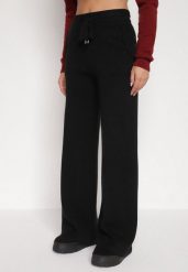 Czarne Dzianinowe Spodnie o Szerokim Kroju ze Sznurkami Melatusa. Czarne jeansy Born2be, l, bez wzorów, z dzianiny, eleganckie, z podwyższonym stanem. Za 99.99 zł.