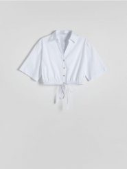 Krótka koszula z wiązaniem - złamana biel. Koszule Reserved, l, bez wzorów, z bawełny, bez kołnierzyka, bez ramiączek. W wyprzedaży za 29.99 zł.