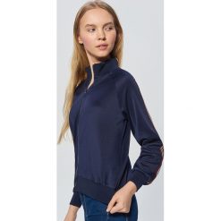 Rozpinana bluza z lampasem - Granatowy. Bluzy marki KALENJI. W wyprzedaży za 39.99 zł.