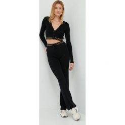 Calvin Klein Jeans spodnie damskie kolor czarny dzwony high waist. Czarne spodnie materiałowe Calvin Klein Jeans, bez wzorów, z dzianiny, z podwyższonym stanem. W wyprzedaży za 404.99 zł.