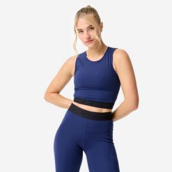 Koszulka fitness damska Domyos crop top. Niebieskie topy sportowe DOMYOS, l, bez wzorów, z elastanu, na fitness i siłownię. Za 69.99 zł.