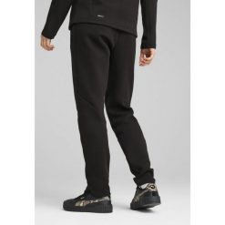Damskie spodnie dresowe EVOSTRIPE PUMA Black. Czarne spodnie dresowe Puma, bez wzorów, z dresówki. W wyprzedaży za 179.00 zł.